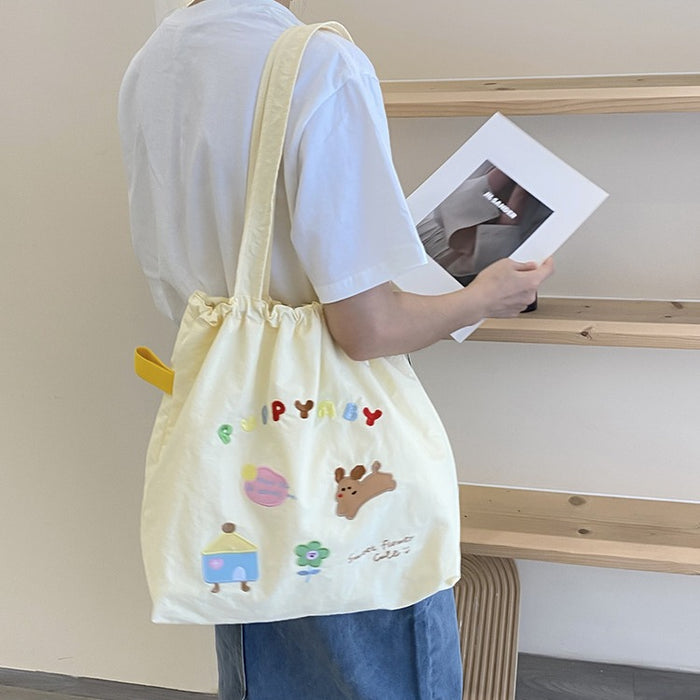 Wholesale New cute cartoon embroidered drawstring shoulder bag, fashionable and simple canvas bag, large capacity tote bag