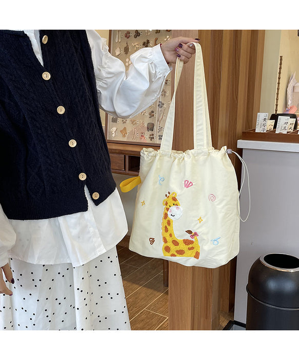 Wholesale Niche cartoon embroidered shoulder bag, simple and large capacity drawstring canvas bag, commuting tote bag for work