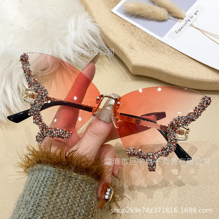 Wholesale Butterfly shaped diamond studded frameless sunglasses for women with fashionable personality and exaggerated sunglasses