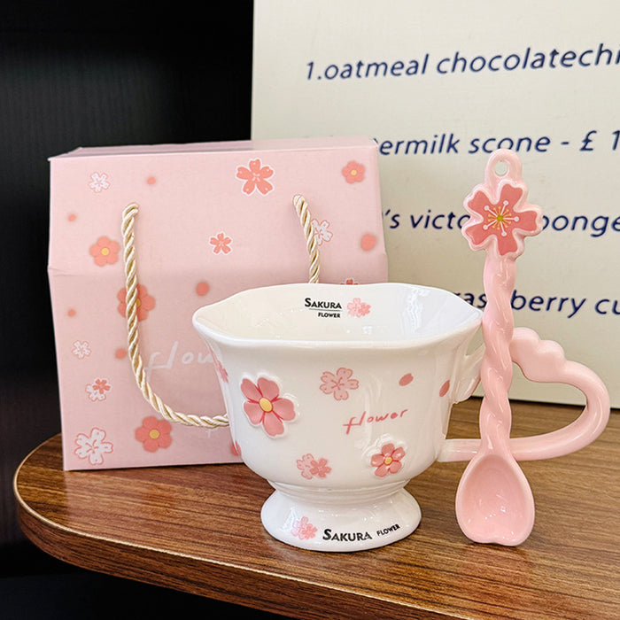 Wholesale Pink ceramic stemmed cup with cherry blossom relief design and spoon