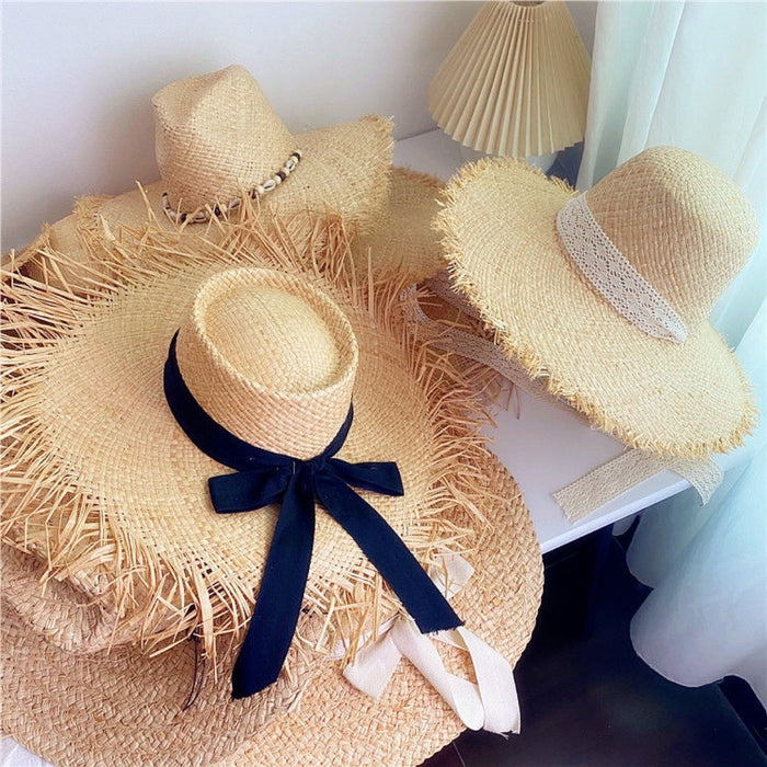 Wholesale Big brim frayed Lafite grass hat women's beach hat for beach vacation, sun protection and sunshade hat
