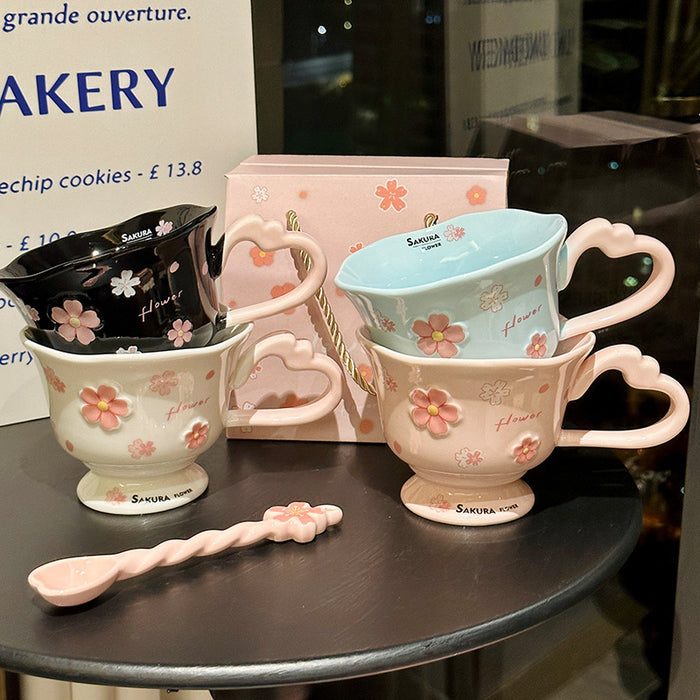 Wholesale Pink ceramic stemmed cup with cherry blossom relief design and spoon