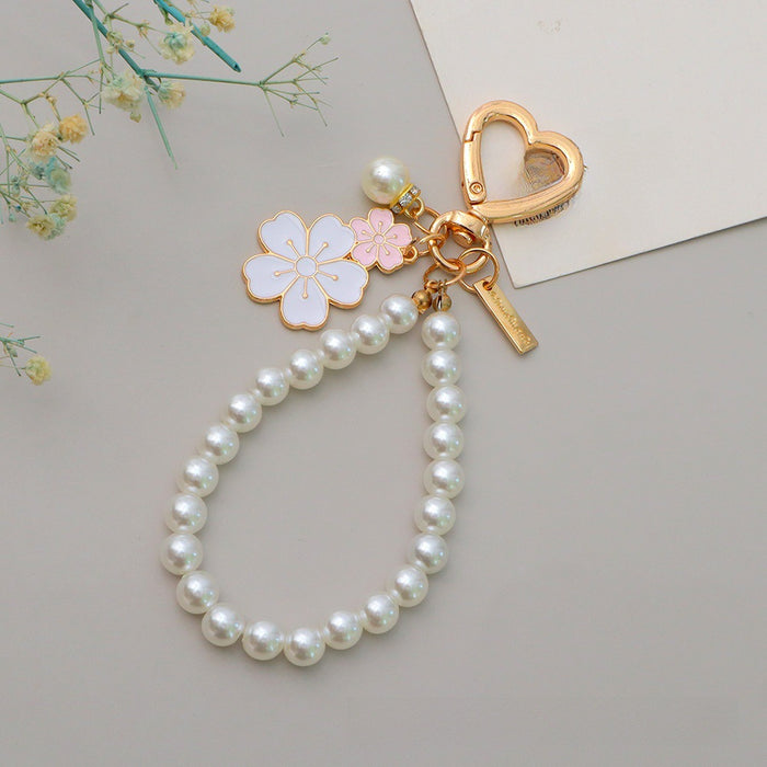 Wholesale Two tone flower alloy keychain pendant, cute letters, pearl accessories, headphone cover, bag, hanging decoration