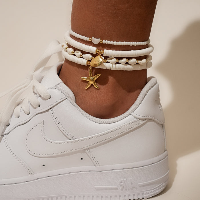 Wholesale Four piece set of shell ankle chains, fashionable and simple, stacked with multiple layers of rice beads woven ankle chains