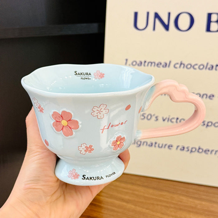 Wholesale Pink ceramic stemmed cup with cherry blossom relief design and spoon