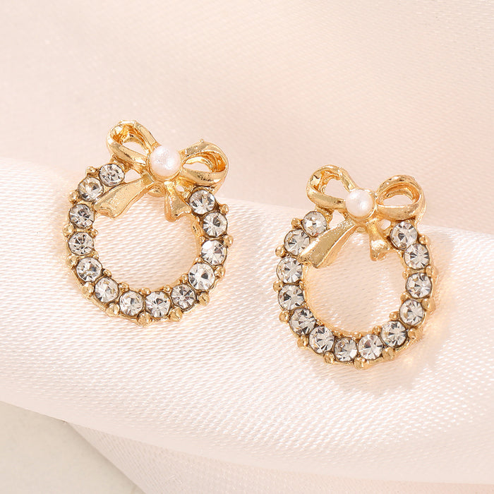 Wholesale Simple pearl bow earrings with personalized temperament, inlaid with colored diamonds, hollowed out circular earrings, and earrings