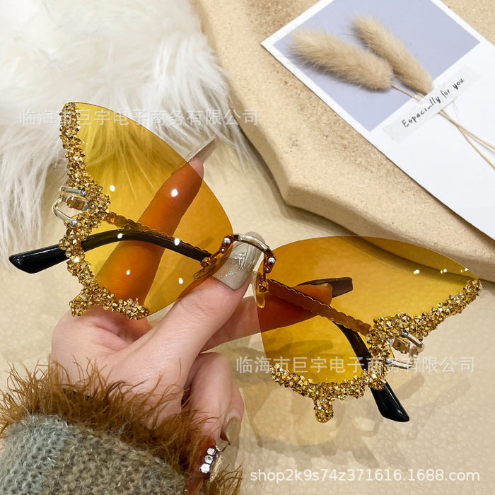Wholesale Butterfly shaped diamond studded frameless sunglasses for women with fashionable personality and exaggerated sunglasses