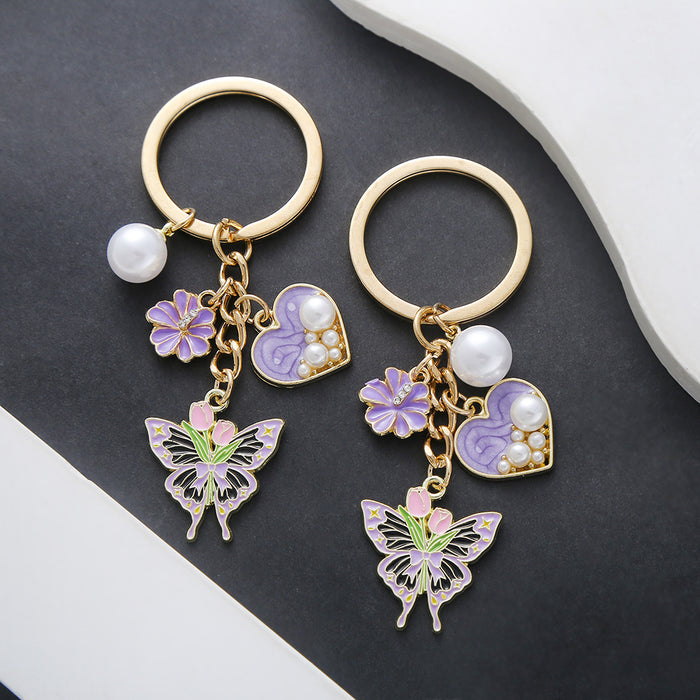 Wholesale Oil-dripping purple heart-shaped pearl tulip flower butterfly metal keychain