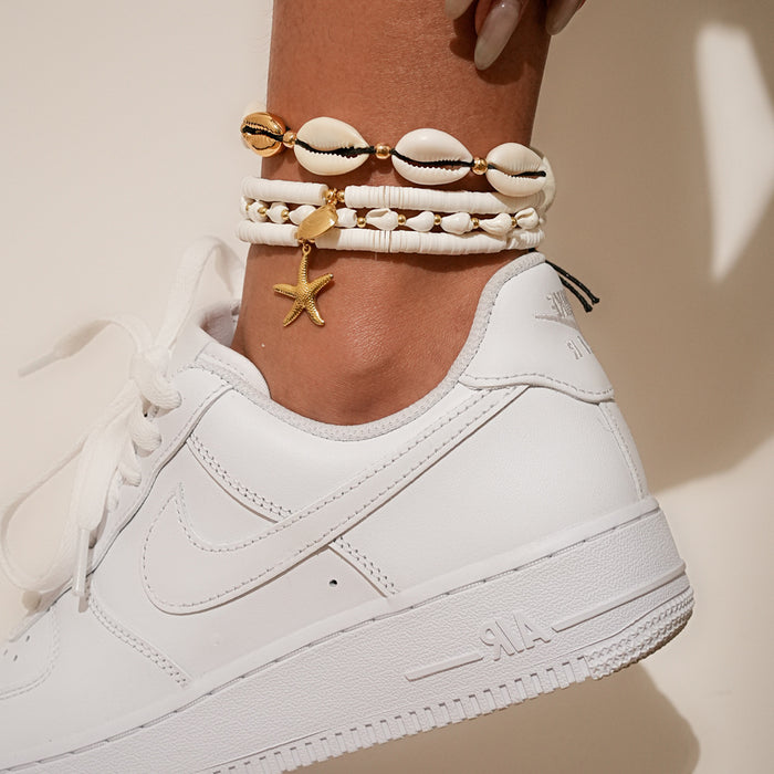 Wholesale Four piece set of shell ankle chains, fashionable and simple, stacked with multiple layers of rice beads woven ankle chains