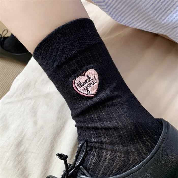 Wholesale Hollow out thin heart-shaped embroidered socks in a pile, tube socks