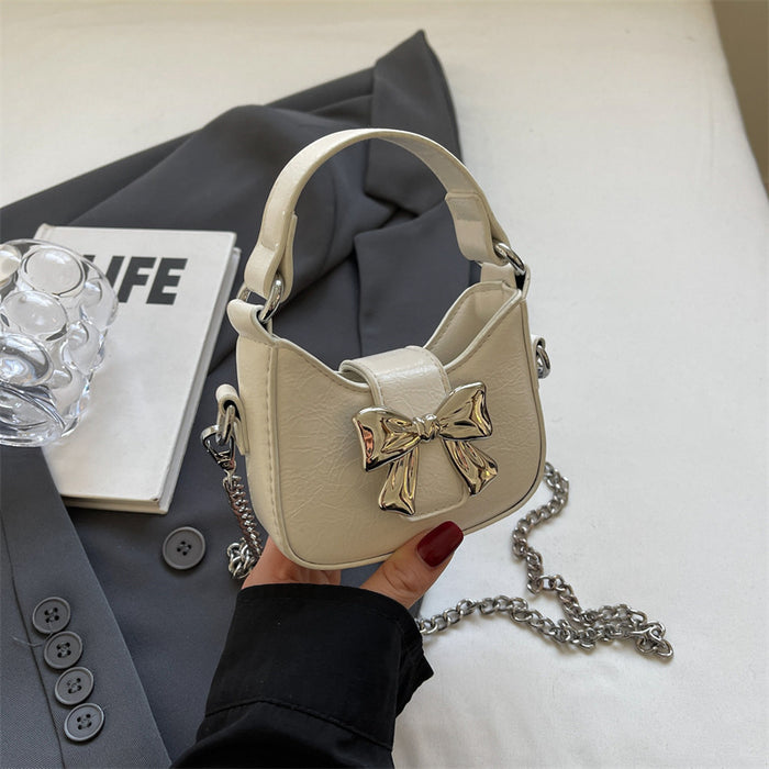 Wholesale New retro oil leather handbag with shiny bow and chain crossbody bag