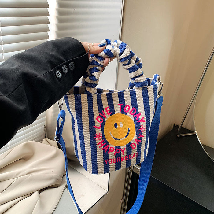 Wholesale Canvas bag, cute smiling face handbag, striped crossbody bag, commuting shoulder bag