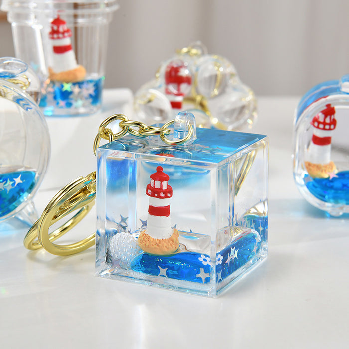 Wholesale Acrylic sailboat lighthouse blue oil-filled quicksand bottle keychain