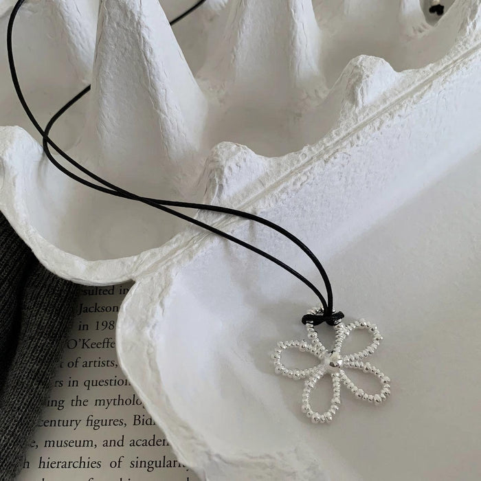 Wholesale Hollow flower necklace, simple black rope, adjustable neckchain, long and versatile collarbone chain