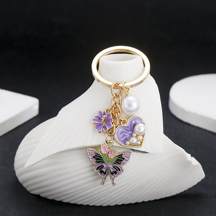 Wholesale Oil-dripping purple heart-shaped pearl tulip flower butterfly metal keychain