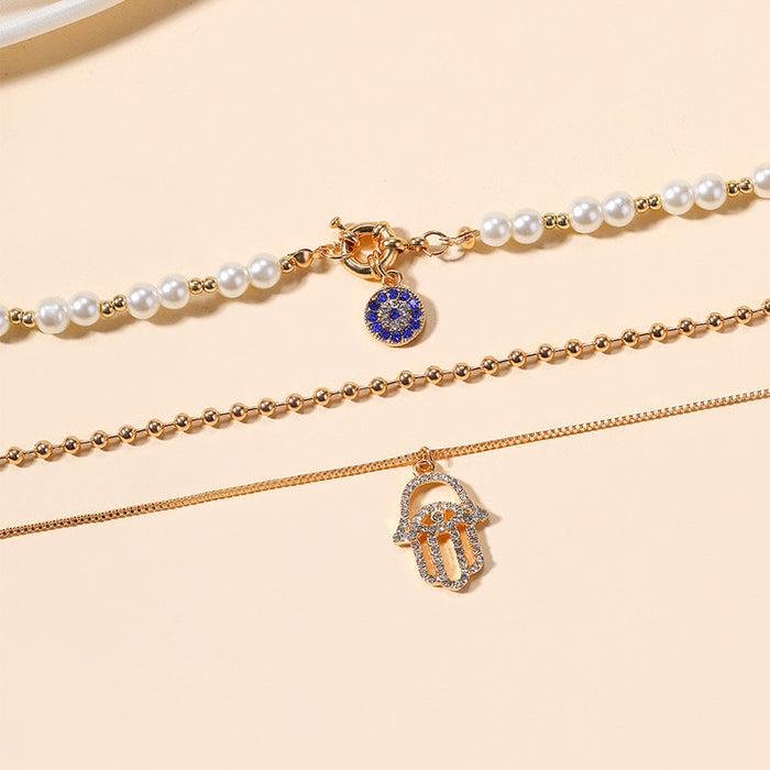 Wholesale New exaggerated jewelry alloy diamond inlaid multi-layer necklace for women, pearl eyes, palm pendant