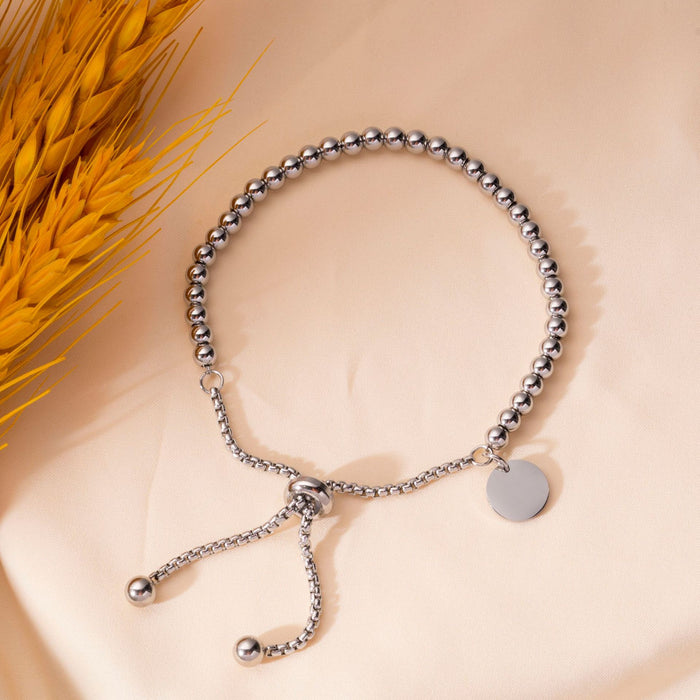 Wholesale Fashionable stainless steel bracelet with simple and fashionable circular hang tag, adjustable round bead, personalized pull-out bracelet
