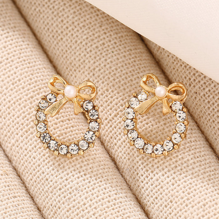 Wholesale Simple pearl bow earrings with personalized temperament, inlaid with colored diamonds, hollowed out circular earrings, and earrings