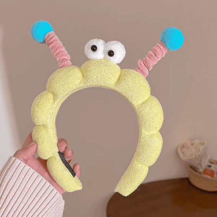 Wholesale Cute girl' s twistable hairband with big-eyed plush toy design.