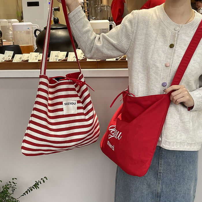 Wholesale New fashionable striped canvas bag with simple and large capacity letter printed double-sided crossbody bag, casual commuting shoulder bag