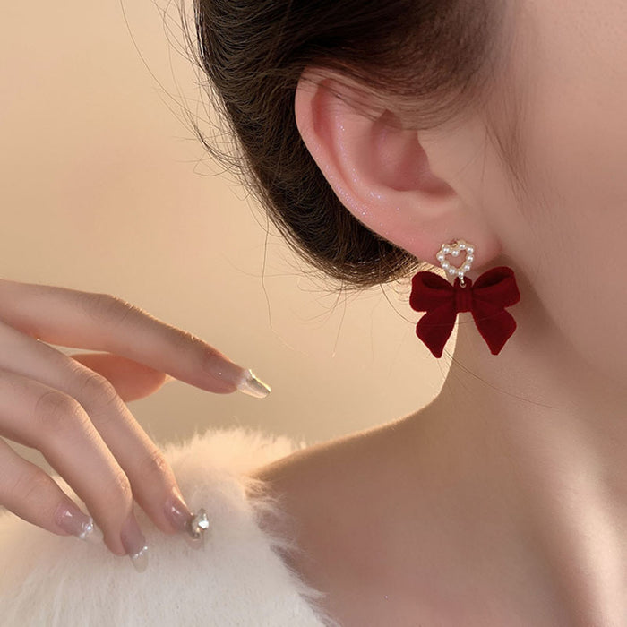 Wholesale autumn and winter flocking bow earrings women sweet love pearl earrings high earrings manufacturers