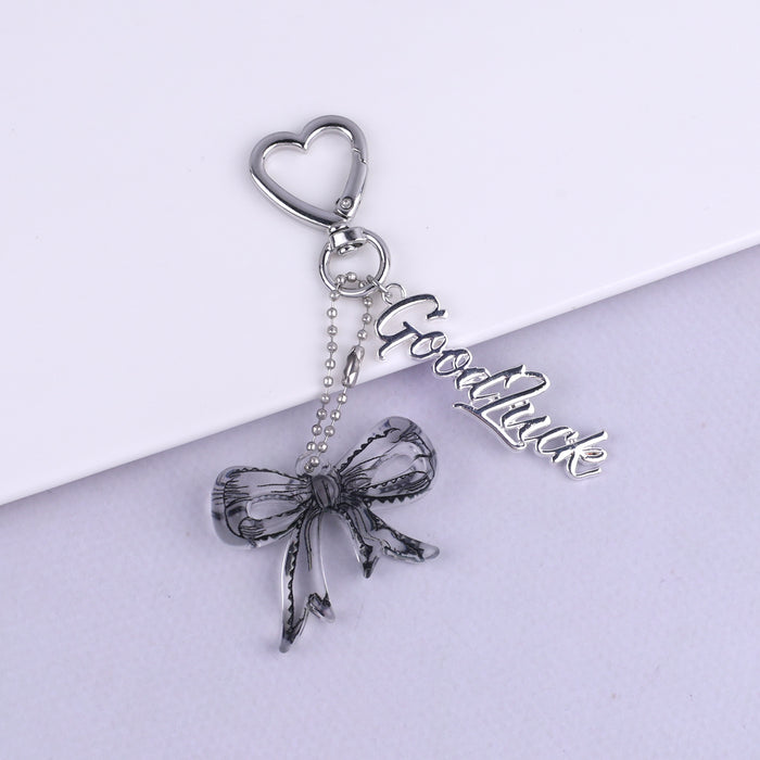 Wholesale Trendy black and white transparent bow acrylic heart keychain bag pendant personalized letter creative accessories
