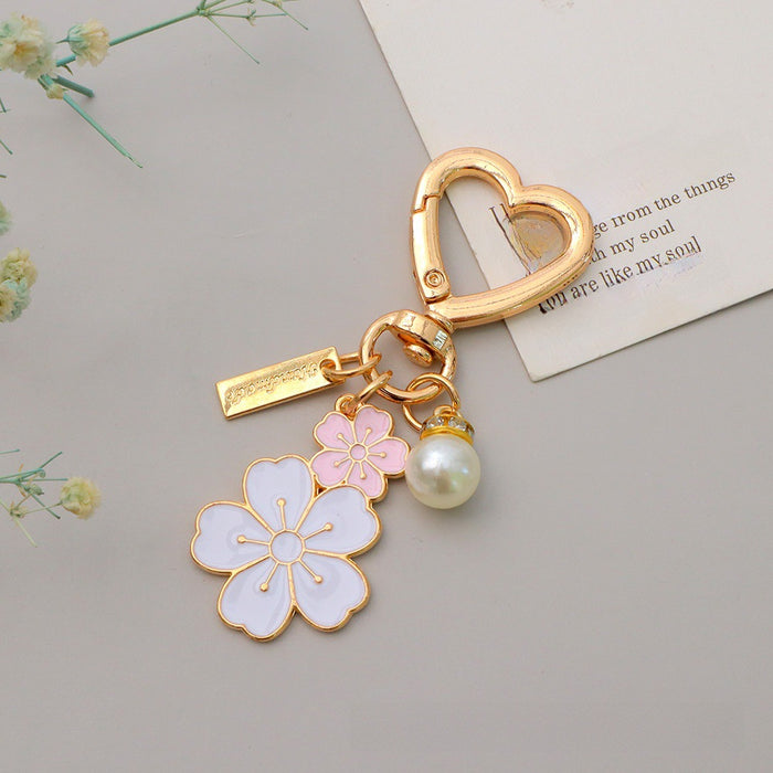 Wholesale Two tone flower alloy keychain pendant, cute letters, pearl accessories, headphone cover, bag, hanging decoration