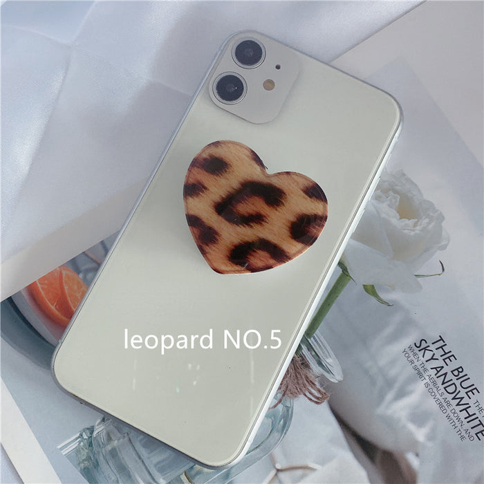 Puques al por mayor soporte de teléfonos móviles Leopardo Impresión Heart en forma de soporte de airbag retráctil MOQ≥2 JDC-PS-Weijiu009