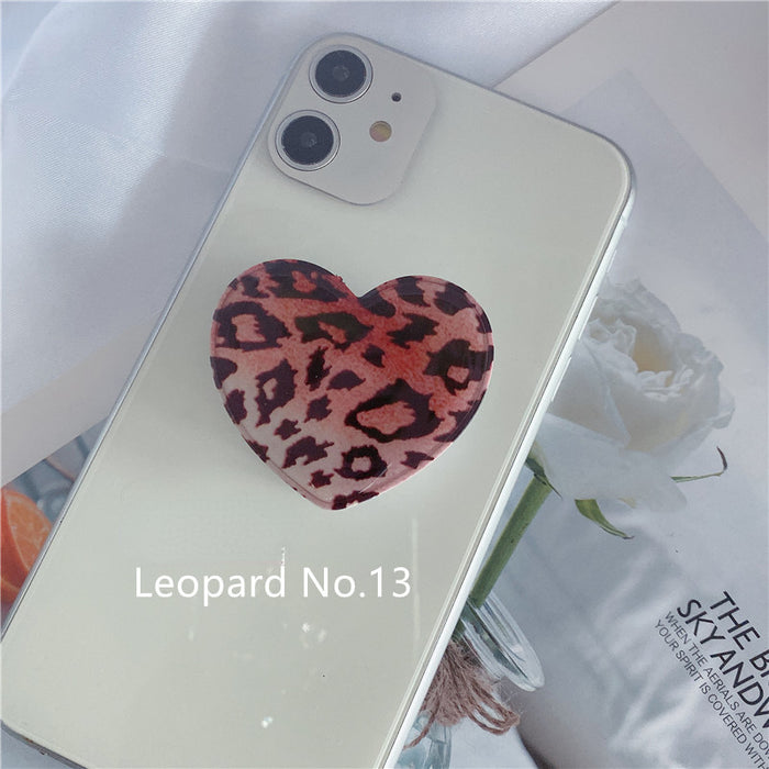 Puques al por mayor soporte de teléfonos móviles Leopardo Impresión Heart en forma de soporte de airbag retráctil MOQ≥2 JDC-PS-Weijiu009